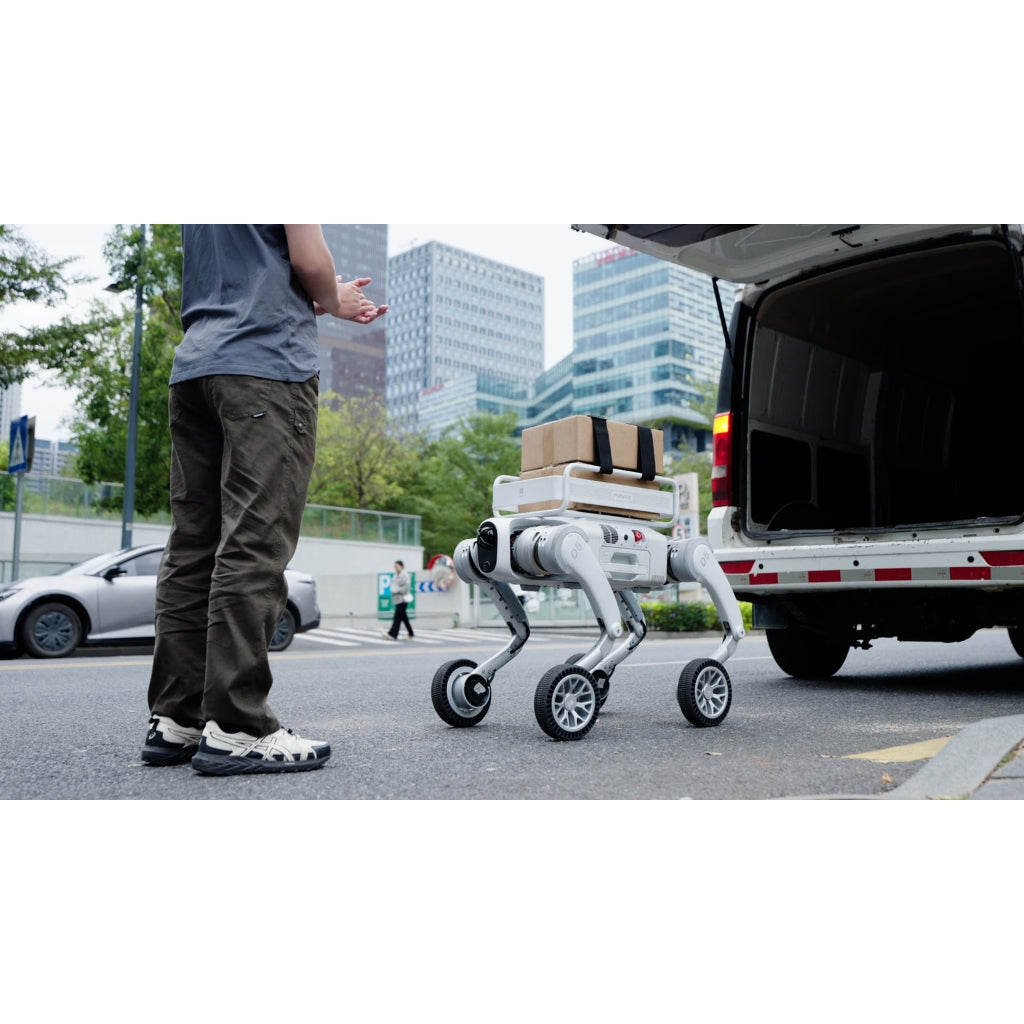 PUDU D5 robot dog carrying a delivery box and following a worker for last-mile logistics.
