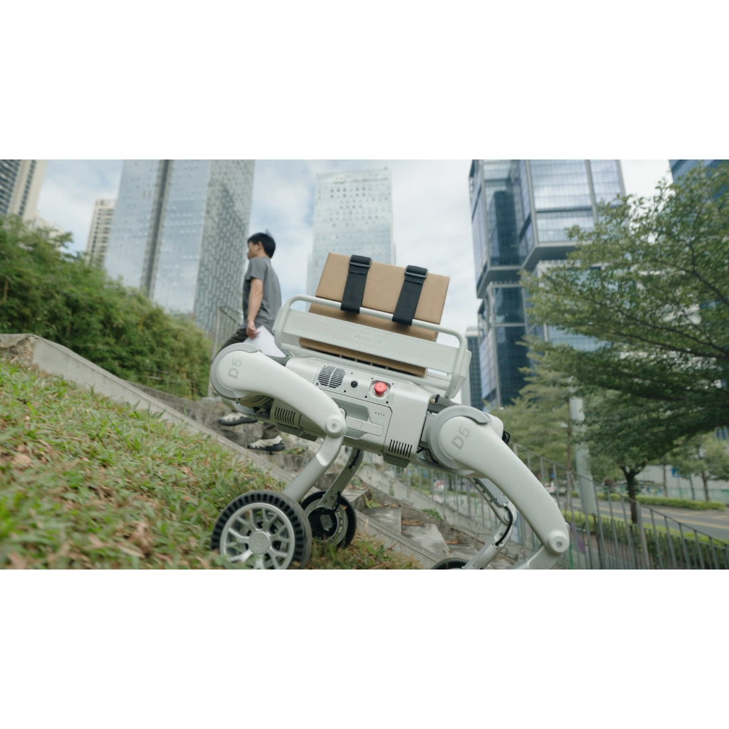 PUDU D5 robot dog climbing a steep grassy slope, demonstrating high-torque motor performance.