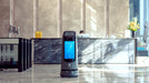 PUDU KettyBot Pro delivery and reception robot in hotel lobby reception area with ad display