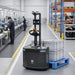 PUDU MP2000 autonomous pallet handling robot delivering materials line-side on a factory floor