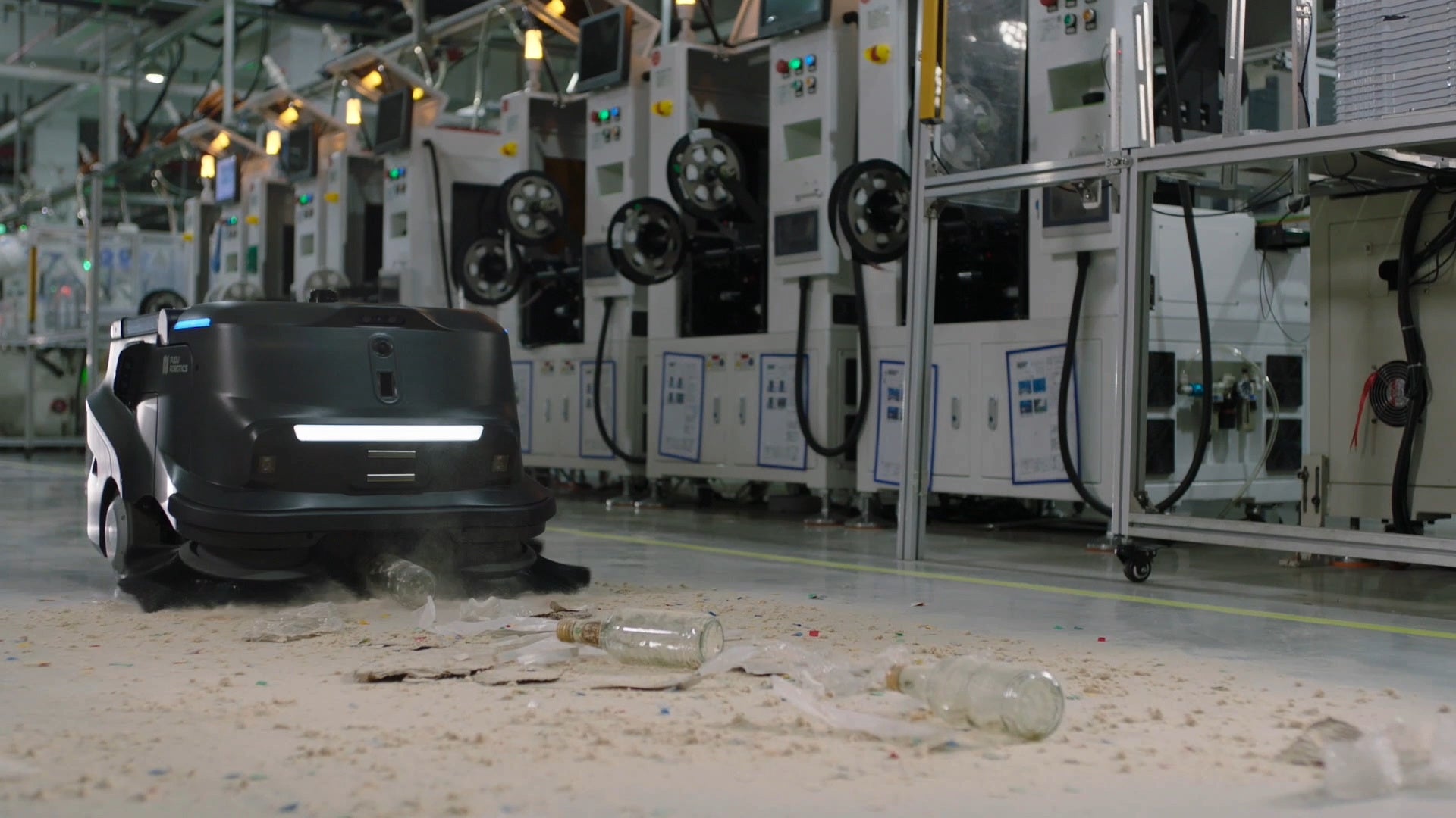PUDU MT1 AI powered robotic sweeper collecting a bottle and debrii