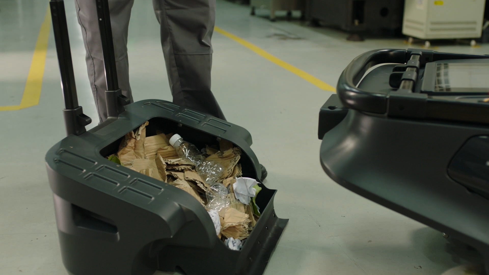 PUDU MT1 AI powered robotic sweeper emptying collection bucket