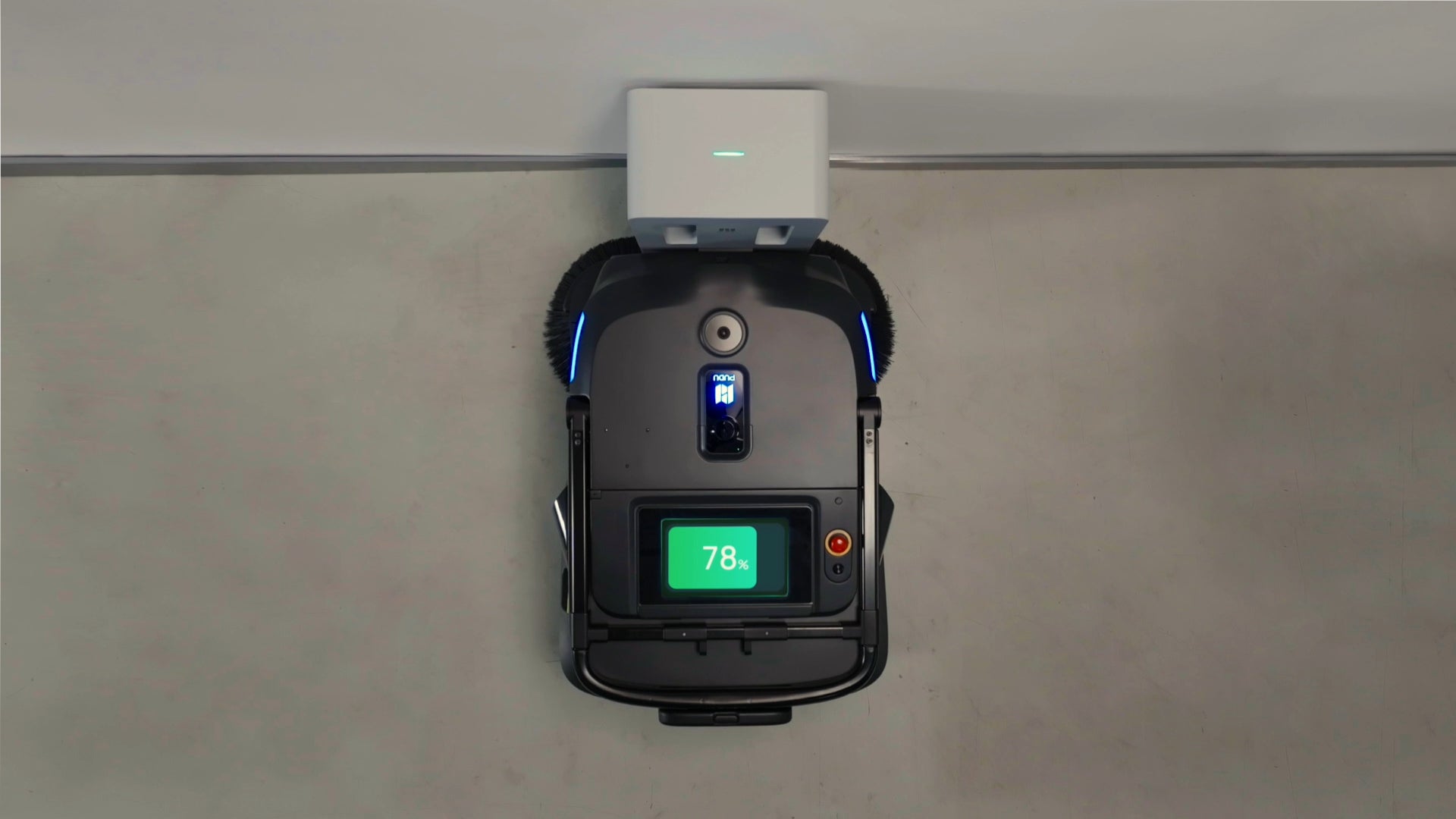PUDU MT1 AI powered robotic sweeper charging at its charge station