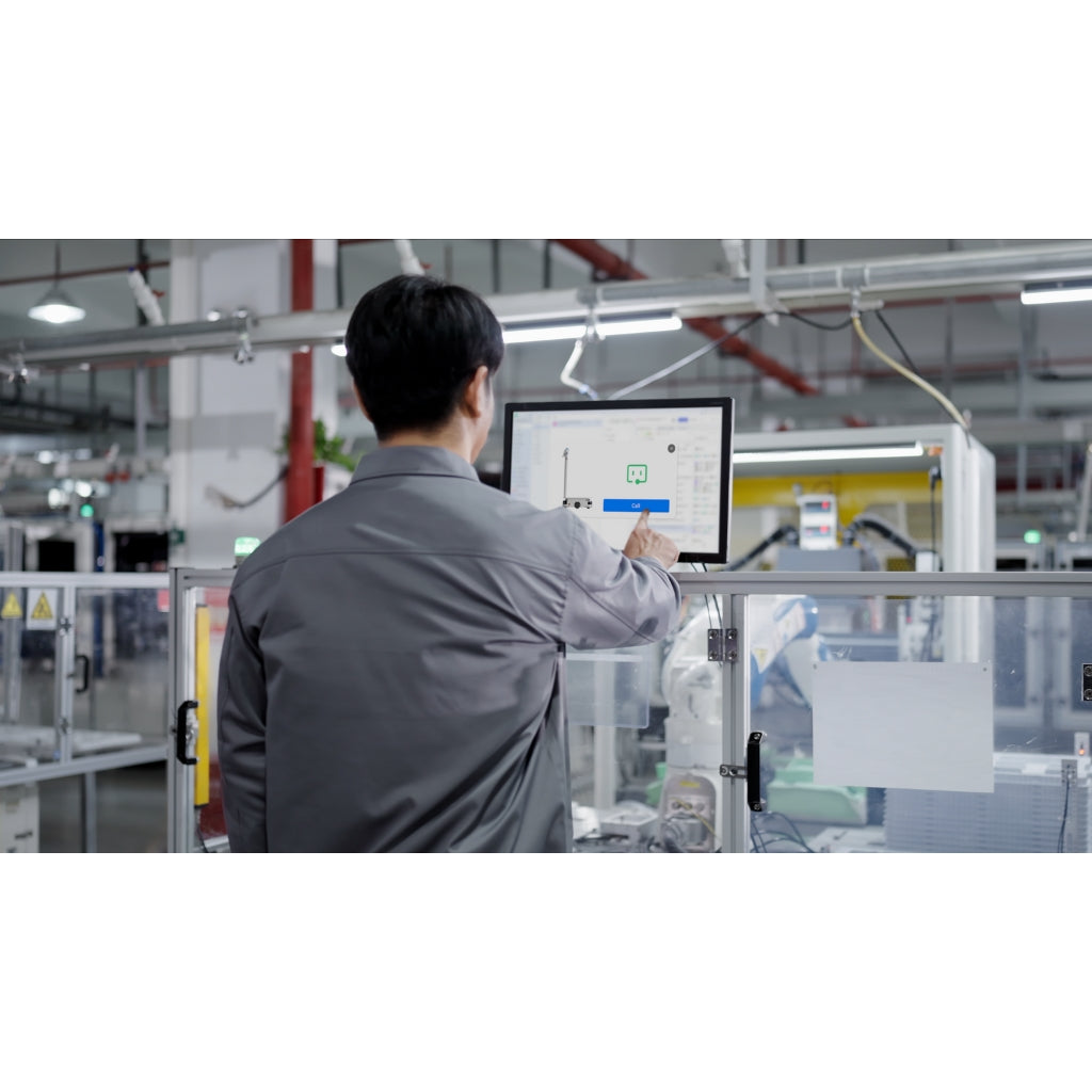 Factory worker using a remote workstation monitor to call and dispatch the PUDU T300 robot to their location.