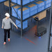 PUDU T600 projecting a red safety warning line on the floor to alert workers of its travel path.